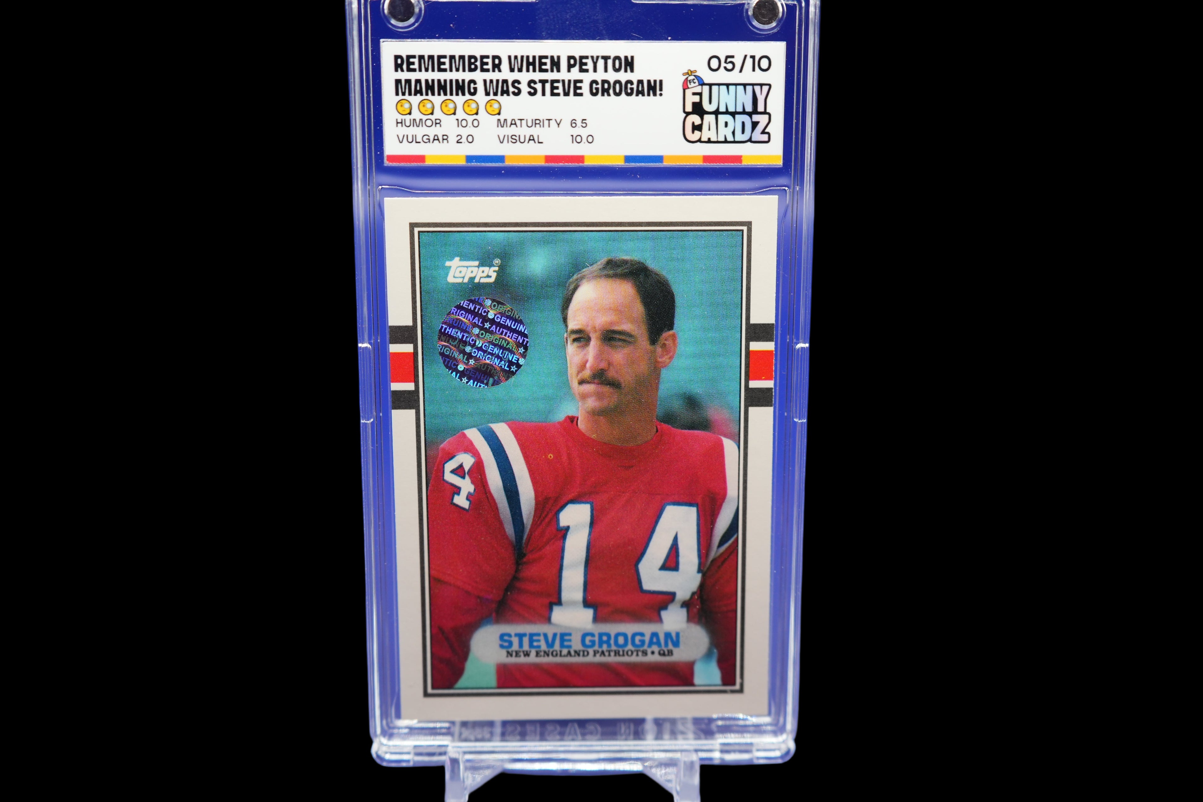 Trading card of Steve Grogan in a protective display case on a blue background