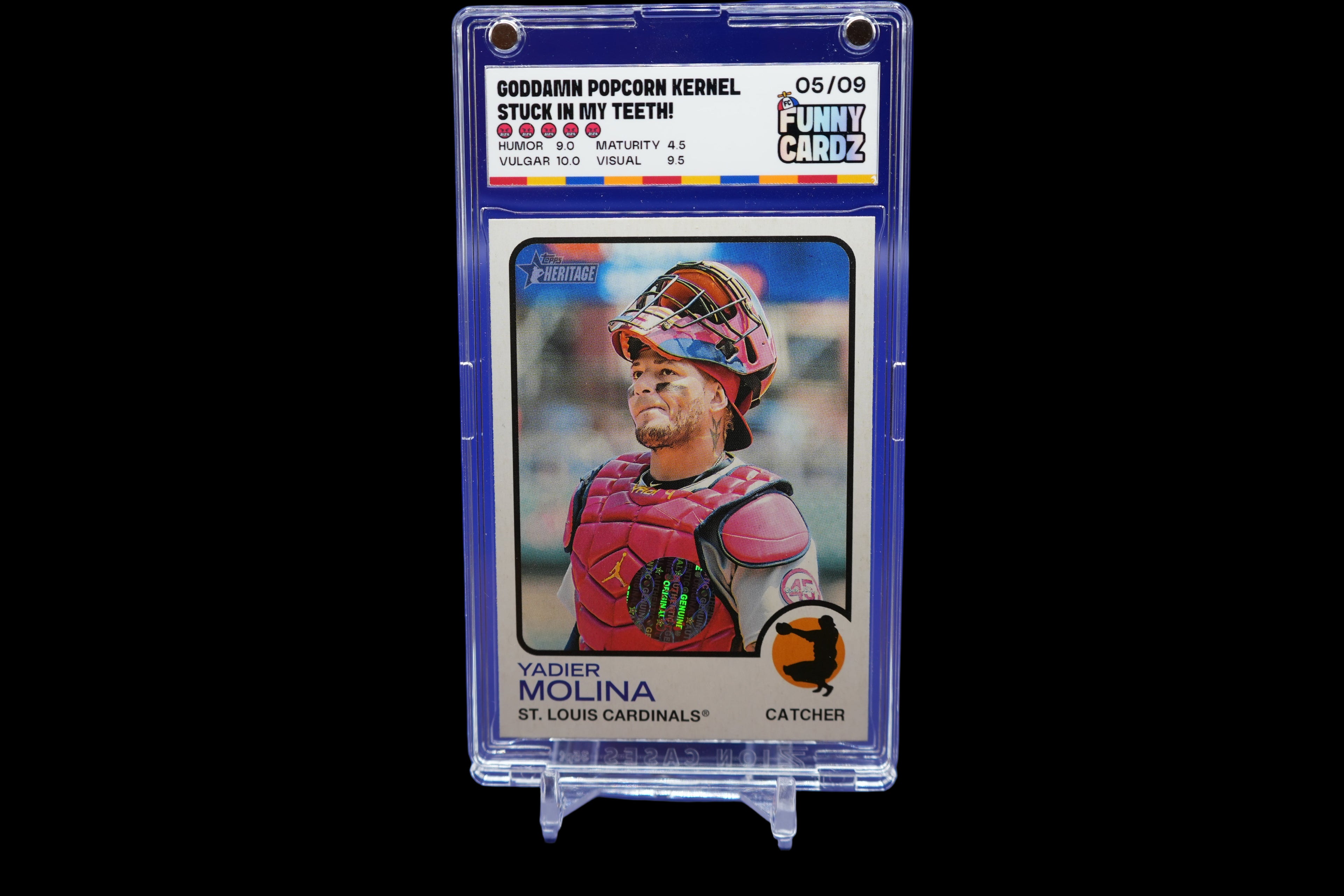 Baseball trading card of Yadier Molina in a display case on a blue background