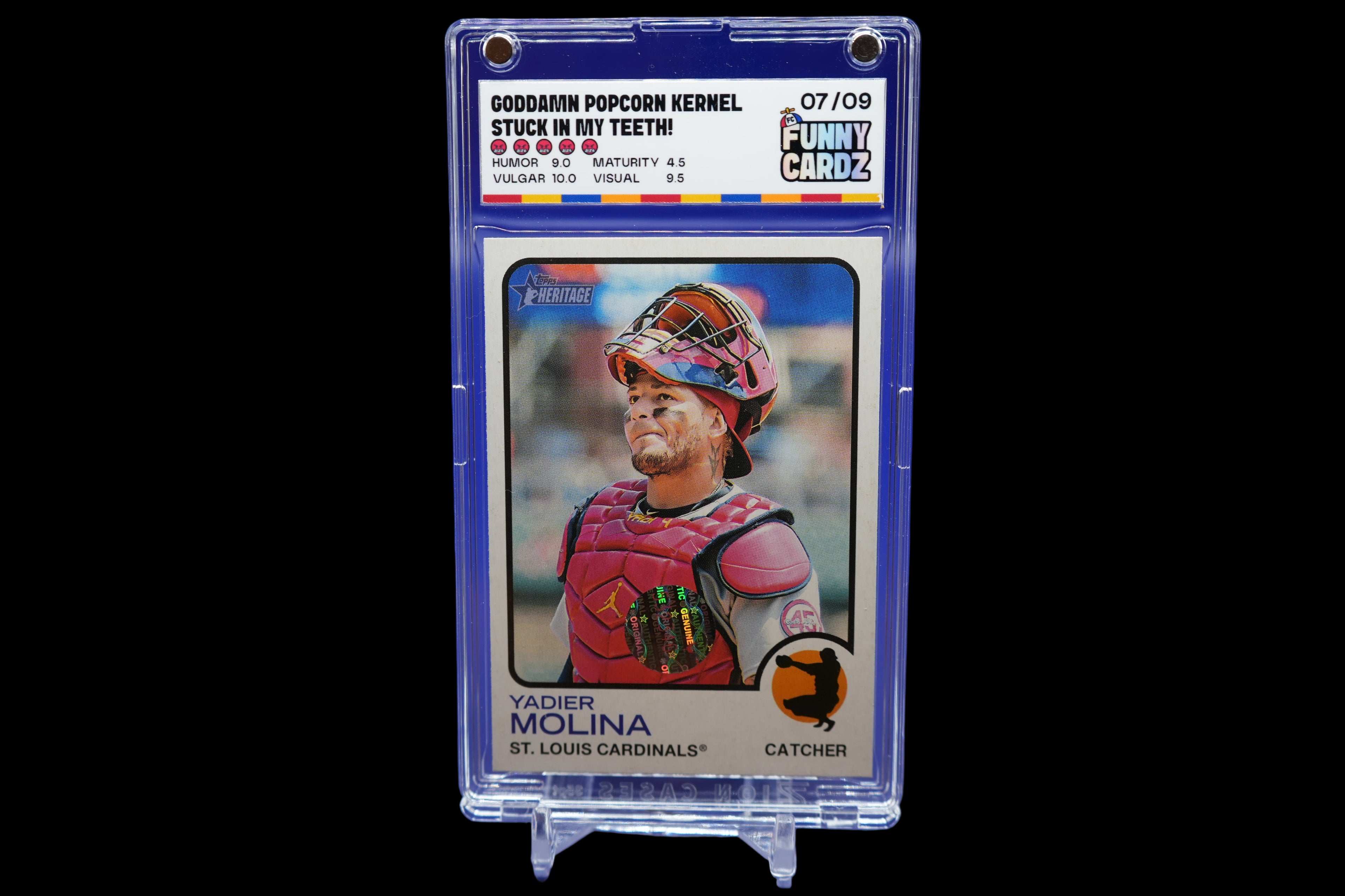 Baseball trading card of Yadier Molina in a display case on a blue background